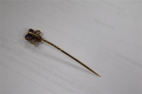 A yellow metal gem set and enamel pendant, a garnet set brooch and a gem set stick pin.